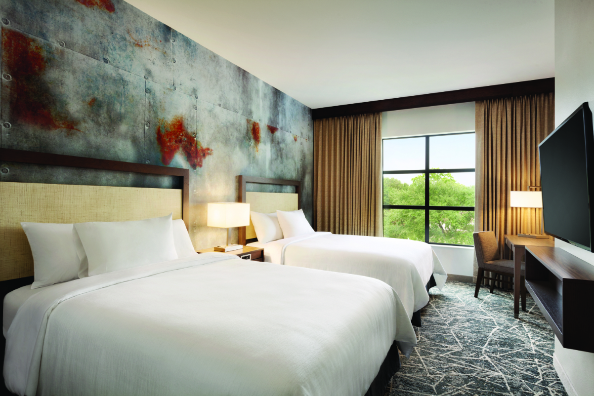 A guest room at the Embassy Suites by Hilton San Antonio Brooks Hotel & Spa. Source: Hilton Worldwide.